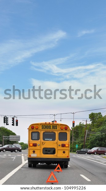 Yellow School Bus Broken\
Down on Blacktop Street at Traffic Light Back Window Sign No\
Sleeping Children