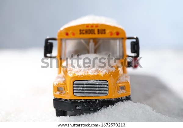 Yellow school bus on snowy road, closeup.\
Transport for students