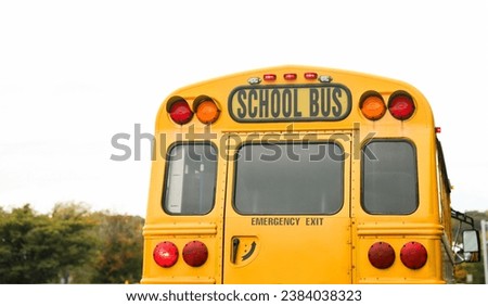 yellow school bus parked in front of a school, symbolizing education, safety, and the journey of learning for children