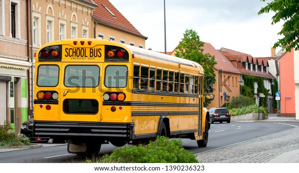 Yellow school bus in the road back to\
school. Children educational transport in\
Europe
