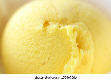 Yellow scoop of fruity ice cream