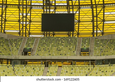 Yellow Seats And Electronic Billboard Display At Stadium