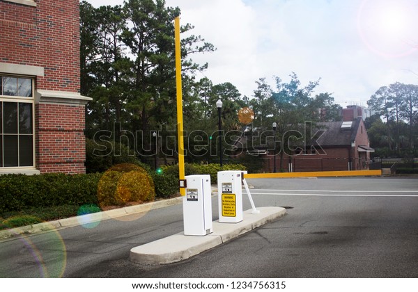 Yellow\
security parking gate with sun flare effect\
filter