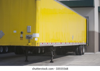 Yellow Semi Trailer Parked In Loading Dock