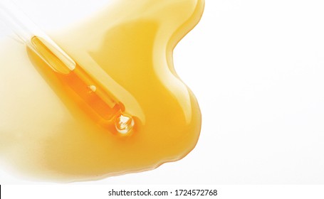Yellow serum or olive oil drop texture isolated on white background, transparent bubble gel cosmetic sample. Golden liquid acid cream swatch or honey drip