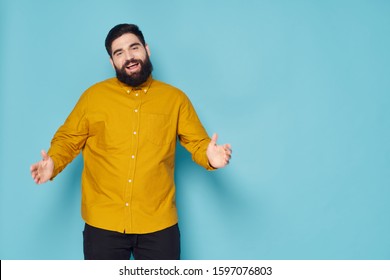 Yellow shirt young man with beard blue pattern background