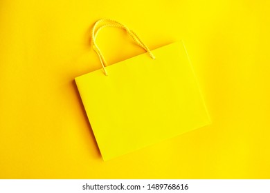 Yellow shopping bag isolated on yellow background - Shutterstock ID 1489768616
