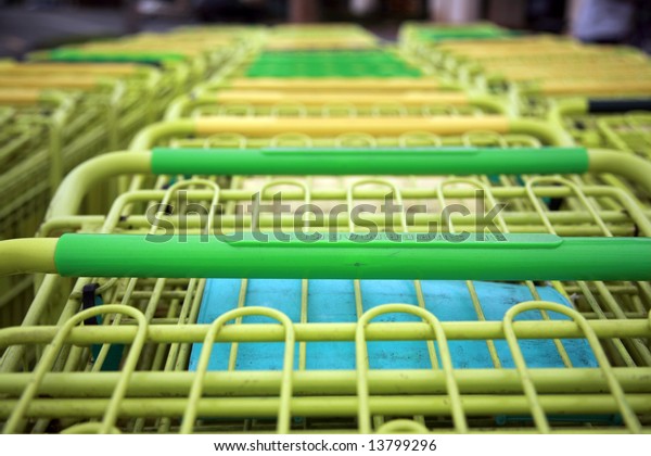 yellow shopping carts in\
a parking lot
