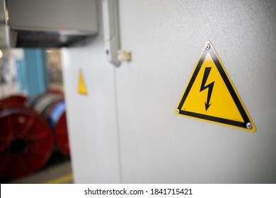 Yellow sigh danger electric shock with lightning in triangle on a metal electric distribution box. 