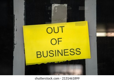 Yellow Sign In Business Window During Time Of Covid Reading 