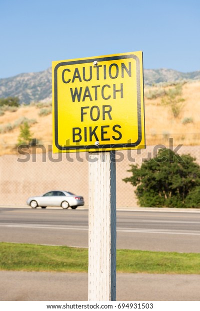 Yellow sign, caution watch\
for bikes