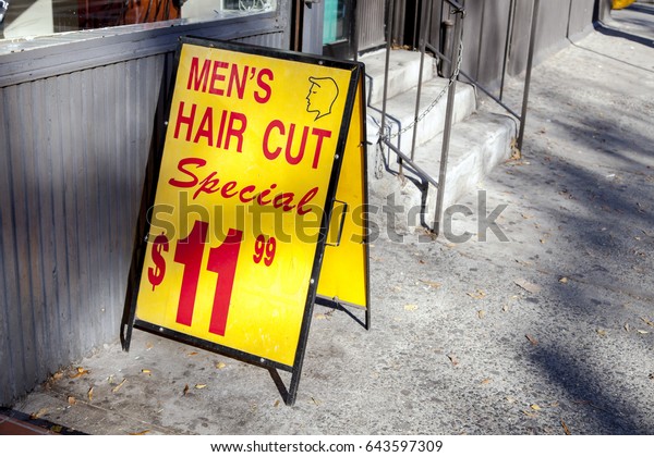 Yellow Sign On Sidewalk Outside Barber Stock Photo Edit Now