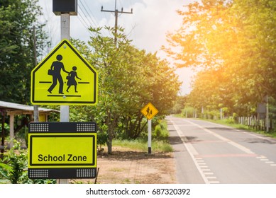 Yellow sign school zone symbol in the countryside . - Powered by Shutterstock