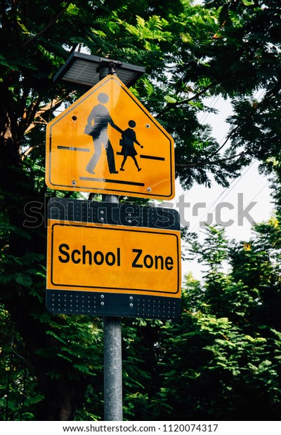 Yellow\
sign school zone symbol with Green\
background.