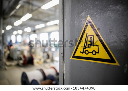 Yellow sign in a warehouse, production - forklift works