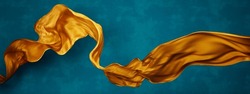
Yellow Silk Fabric Floating In Front Of Blue Background Wall. Flying Satin Scarf Abstract Shape. Luxury Fashion Aesthetic.