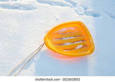 Yellow Sled With A Rope On White Snow