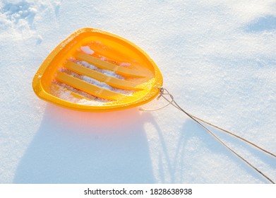 Yellow Sled With A Rope On White Snow