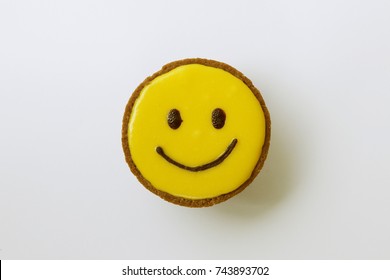 Yellow Smile Face Cup Cake On White Background.