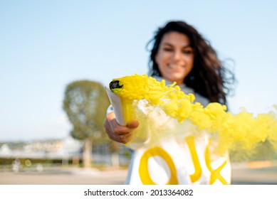 A Yellow Smoke Bomb In The Hands Of A Girl.