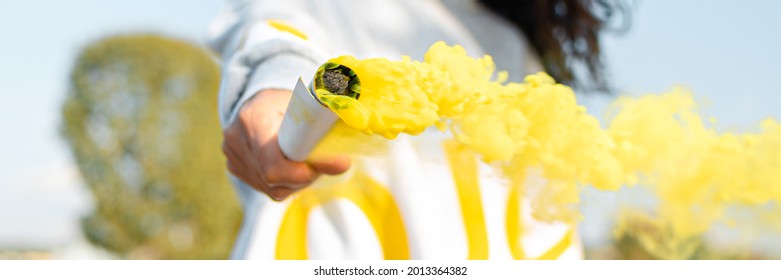 A Yellow Smoke Bomb In The Hands Of A Girl.