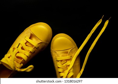 Yellow Sneakers On A Black Background