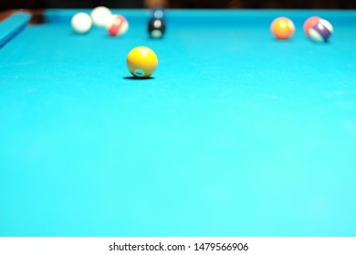 Yellow Snooker Ball On The Blue Table. Goal Concept.