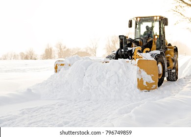 Yellow Snow Plow Cleaning A Road