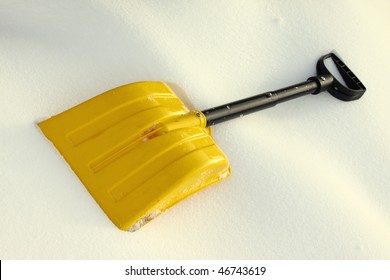 Yellow Snow Shovel Lying On The Snow