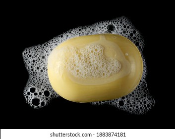 Yellow Soap Bar With Foam, Lather And Bubbles Isolated On Black Background Texture Clipping Path, Top View