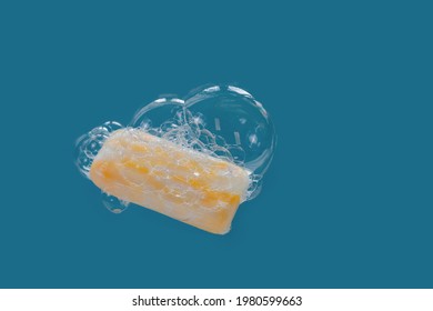 Yellow soap surrounded by soap bubbles and heart-shaped foam on a blue background. The joy and love of body care procedures.  - Powered by Shutterstock