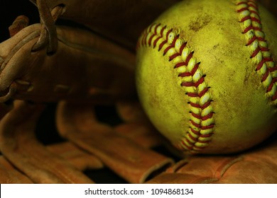 Yellow Softball In A Brown Glove.