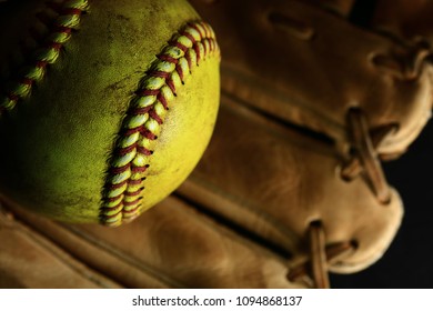 Yellow Softball In A Brown Glove.