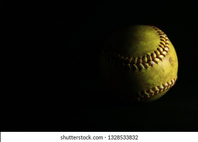 Yellow Softball On Black Background.