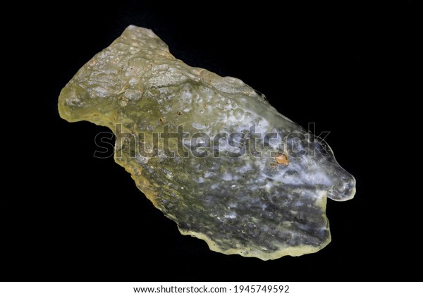 Yellow specimen of Libyan desert glass. Translucent\
to transparent, weighing 21.7 grams. Surface is smooth, mottled,\
with evidence of flowing motion. Photographed with black background\
in natural ligh