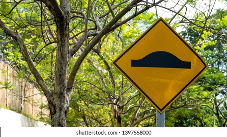 Yellow Speed Bump Ahead Street Sign