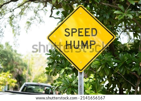 Yellow speed hump ahead warning sign on Florida neighborhood street