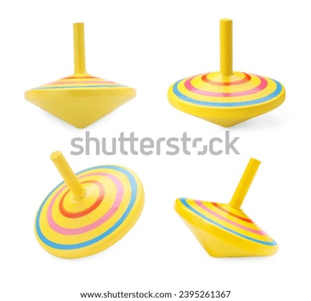 Yellow spinning tops isolated on white. Toy whirligig