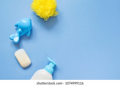 Yellow Sponge, Blue Plastic Toy Dolphin And Liquid Soap. Flat Lay Baby Bath Products. Mockup