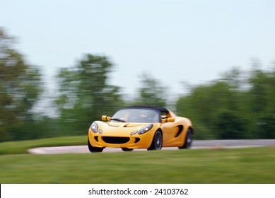 Yellow Sports Car Racing At A Open Track Day