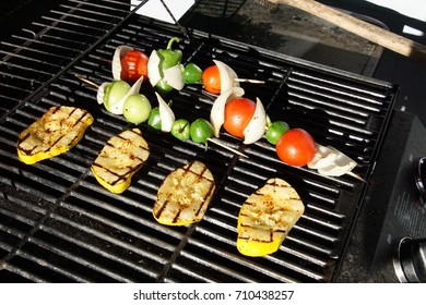 Yellow squash tomato and onion on the grill on a summer day in Seattle, Washington - Shutterstock ID 710438257