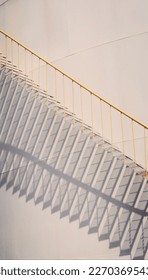 yellow stairs with white walls as background form a beautiful shadow