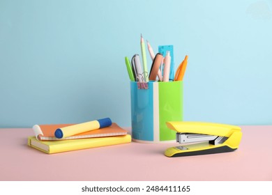 Yellow stapler and other stationery on color background - Powered by Shutterstock