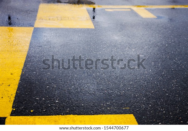 Yellow start and\
finish line motor race,  yellow lines on wet asphalt road\
space\
for text on background,\
DTM