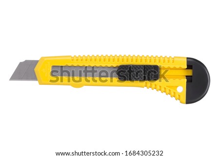 Yellow stationery knife with a blade isolated on a white background
