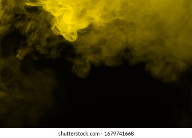 Yellow steam on a black background. Copy space.