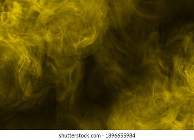 Yellow steam on a black background. Copy space.