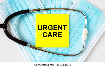 Yellow Sticker With Text Urgent Care Lying On The Masks And Stethoscope. Medical Concept