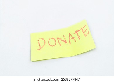 Yellow Sticky Note with Handwritten Red 'Donate' Message - Powered by Shutterstock