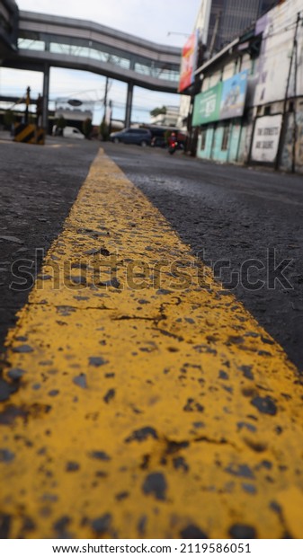 Yellow\
street lines. Road divider to pedestrian\
bridges